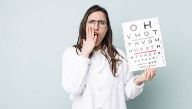 young pretty woman  feeling shocked and scared. optical vision test concept