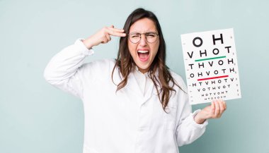 young pretty woman  looking unhappy and stressed, suicide gesture making gun sign. optical vision test concept