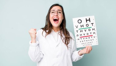 young pretty woman  shouting aggressively with an angry expression. optical vision test concept