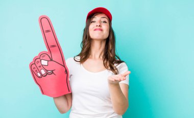 young pretty woman  smiling happily with friendly and  offering and showing a concept. number one hand fan