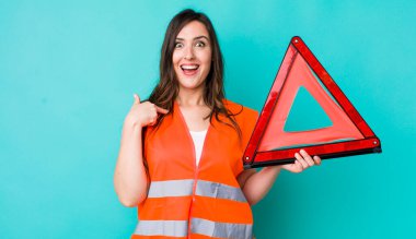 young pretty woman  feeling happy and pointing to self with an excited. car emergency triangle
