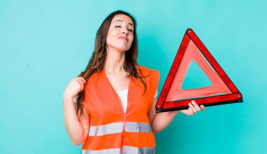young pretty woman  looking arrogant, successful, positive and proud. car emergency triangle