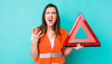 young pretty woman  looking angry, annoyed and frustrated. car emergency triangle