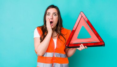 young pretty woman  feeling shocked and scared. car emergency triangle