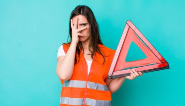 young pretty woman  feeling bored, frustrated and sleepy after a tiresome. car emergency triangle