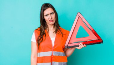 young pretty woman  feeling puzzled and confused. car emergency triangle