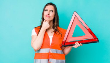 young pretty woman  thinking, feeling doubtful and confused. car emergency triangle
