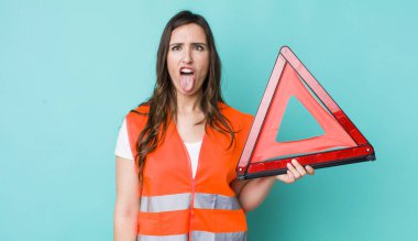 young pretty woman  feeling disgusted and irritated and tongue out. car emergency triangle