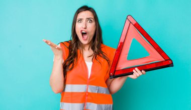 young pretty woman  feeling extremely shocked and surprised. car emergency triangle