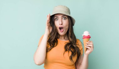 young pretty woman  looking happy, astonished and surprised. summer and ice cream concept