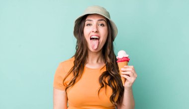 young pretty woman  with cheerful and rebellious attitude, joking and sticking tongue out. summer and ice cream concept