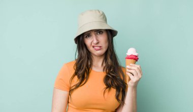 young pretty woman  feeling sad and whiney with an unhappy look and crying. summer and ice cream concept