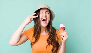 young pretty woman  looking unhappy and stressed, suicide gesture making gun sign. summer and ice cream concept