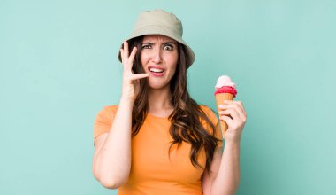 young pretty woman  screaming with hands up in the air. summer and ice cream concept