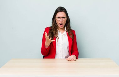 Genç ve güzel bir kadın sinirli, sinirli ve sinirli görünüyor. iş kavramı