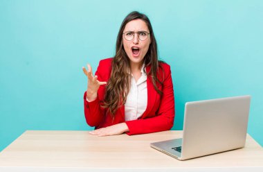 young pretty woman  looking angry, annoyed and frustrated. business desk concept