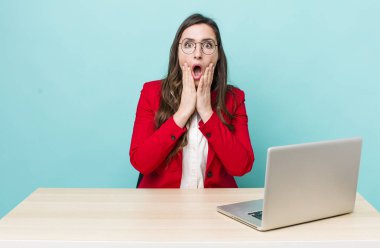 young pretty woman  feeling shocked and scared. business desk concept