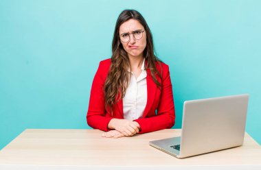 young pretty woman  feeling sad and whiney with an unhappy look and crying. business desk concept