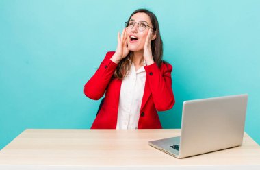 young pretty woman  feeling happy, excited and surprised. business desk concept