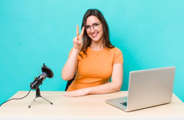 young pretty woman  smiling and looking friendly, showing number two. influencer concept