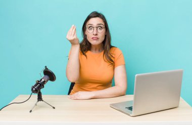 young pretty woman  making capice or money gesture, telling you to pay. influencer concept