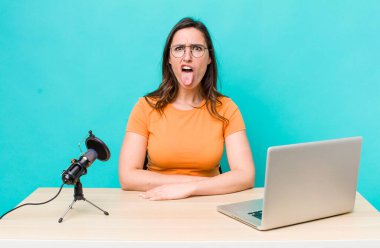 young pretty woman  feeling disgusted and irritated and tongue out. influencer concept