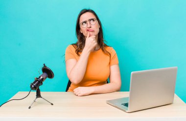 young pretty woman  thinking, feeling doubtful and confused. influencer concept