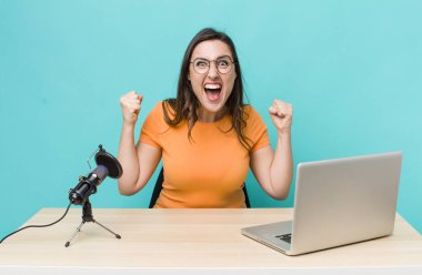 young pretty woman  shouting aggressively with an angry expression. influencer concept