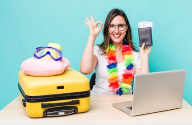 young pretty woman  feeling happy, showing approval with okay gesture. summer travel concept