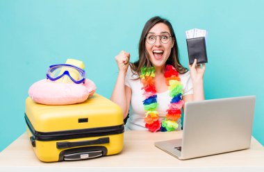 young pretty woman  feeling shocked,laughing and celebrating success. summer travel concept