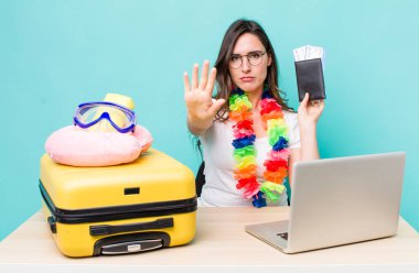 young pretty woman  looking serious showing open palm making stop gesture. summer travel concept
