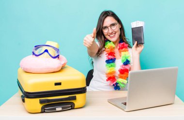 young pretty woman  feeling proud,smiling positively with thumbs up. summer travel concept