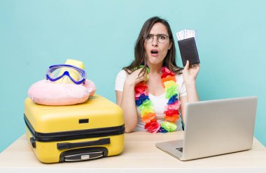 young pretty woman  looking very shocked or surprised. summer travel concept