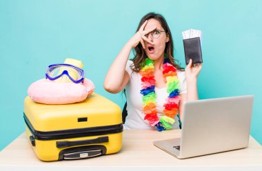 young pretty woman  looking shocked, scared or terrified, covering face with hand. summer travel concept