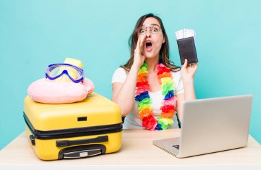 young pretty woman  feeling happy,giving a big shout out with hands next to mouth. summer travel concept