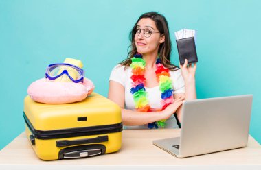 young pretty woman  shrugging, feeling confused and uncertain. summer travel concept