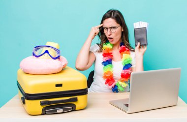 young pretty woman  feeling confused and puzzled, showing you are insane. summer travel concept