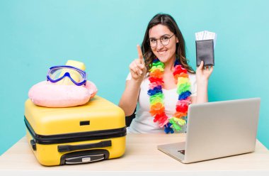 young pretty woman  smiling and looking friendly, showing number one. summer travel concept