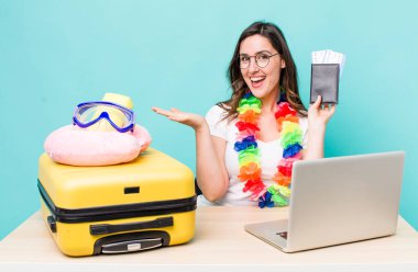 young pretty woman  smiling cheerfully, feeling happy and showing a concept. summer travel concept