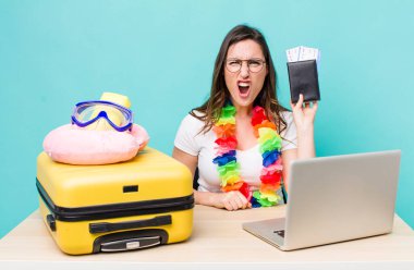 young pretty woman  shouting aggressively, looking very angry. summer travel concept