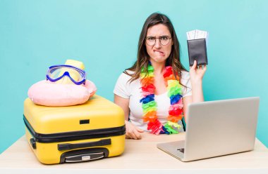 young pretty woman  looking puzzled and confused. summer travel concept