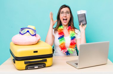 young pretty woman  screaming with hands up in the air. summer travel concept