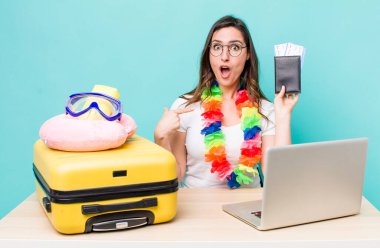 young pretty woman  looking shocked and surprised with mouth wide open, pointing to self. summer travel concept