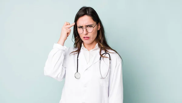 Young Pretty Woman Feeling Confused Puzzled Showing You Insane Physician — Stockfoto