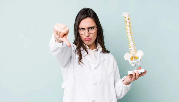 Young Pretty Woman Feeling Cross Showing Thumbs Spine Specialist Concept — Stockfoto
