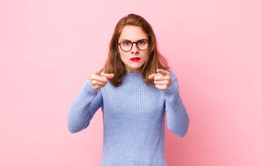 Genç ve güzel bir kadın kameraya iki parmağıyla ve kızgın bir ifadeyle sana görevini yapmanı söylüyor.