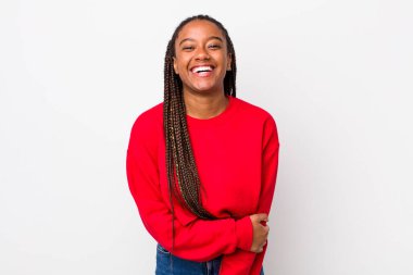 afro pretty woman laughing shyly and cheerfully, with a friendly and positive but insecure attitude