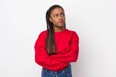 afro pretty woman doubting or thinking, biting lip and feeling insecure and nervous, looking to copy space on the side