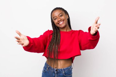 afro pretty woman smiling cheerfully giving a warm, friendly, loving welcome hug, feeling happy and adorable