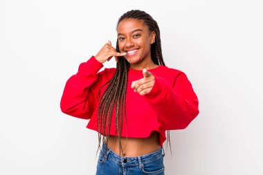 afro pretty woman smiling cheerfully and pointing to camera while making a call you later gesture, talking on phone